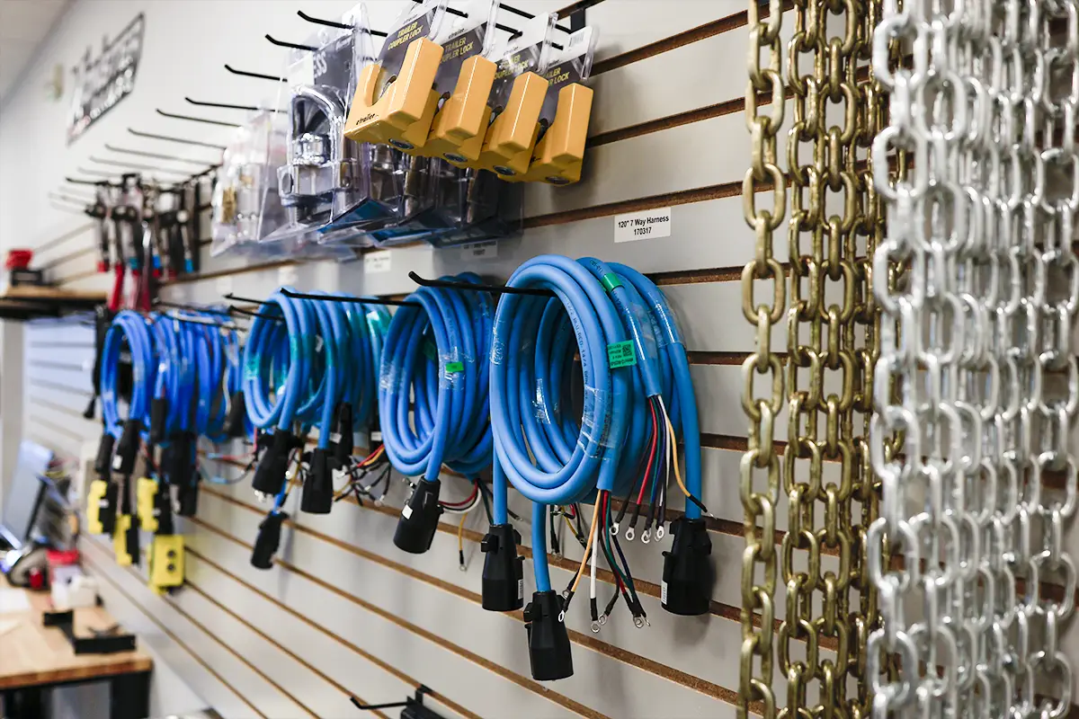 trailer-parts-for-sale-happy-trailers Trailer wiring harnesses, hitch locks, and safety chains for sale at Happy Trailers parts department